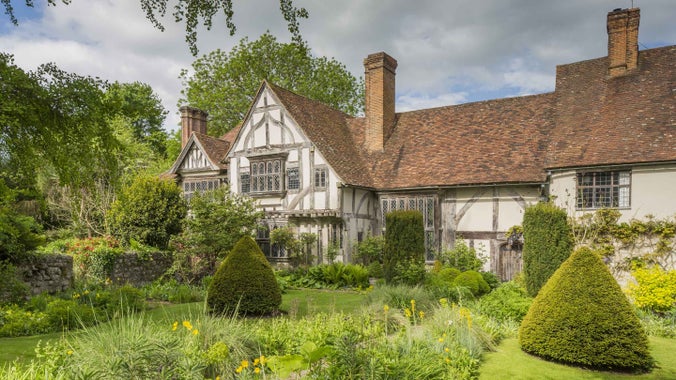 The front garden at Stoneacre in Kent showing conical topiary and greenery